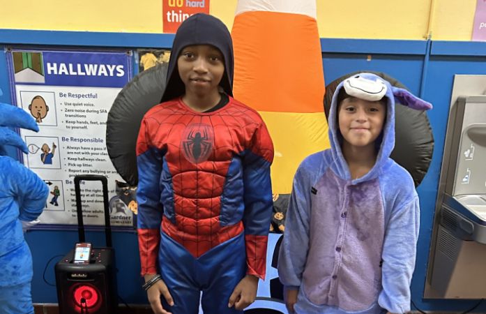  students posing in costumes
